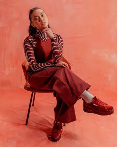Abby modeling in a a red outfit with red shoes for PUMA
