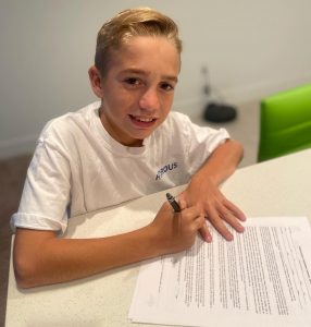 Maeson signing his agency contract