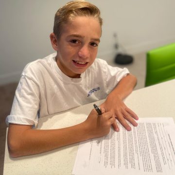 Maeson signing his agency contract