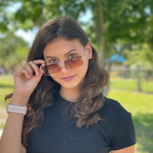 Francesca posing outside wearing sunglasses