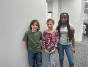 Phillip, Ella, and Maliha posing on set for the video shoot