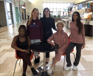 behind the scenes shot of Red Bank models posing together at the mall at the health and wellness fashion show