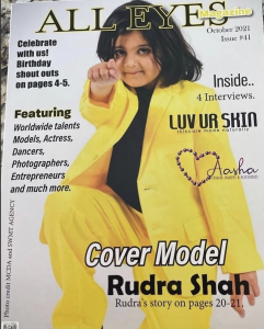 Rudra modeling in a yellow suit on the cover for All Eyes Magazine