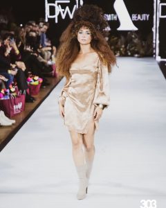 Nadie walking on the runway at Denver Fashion Week in shot from 303 Magazine