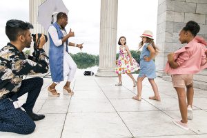 Yemi on set of a photoshoot working with young models