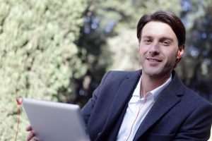 Confident man smiling in front of a computer